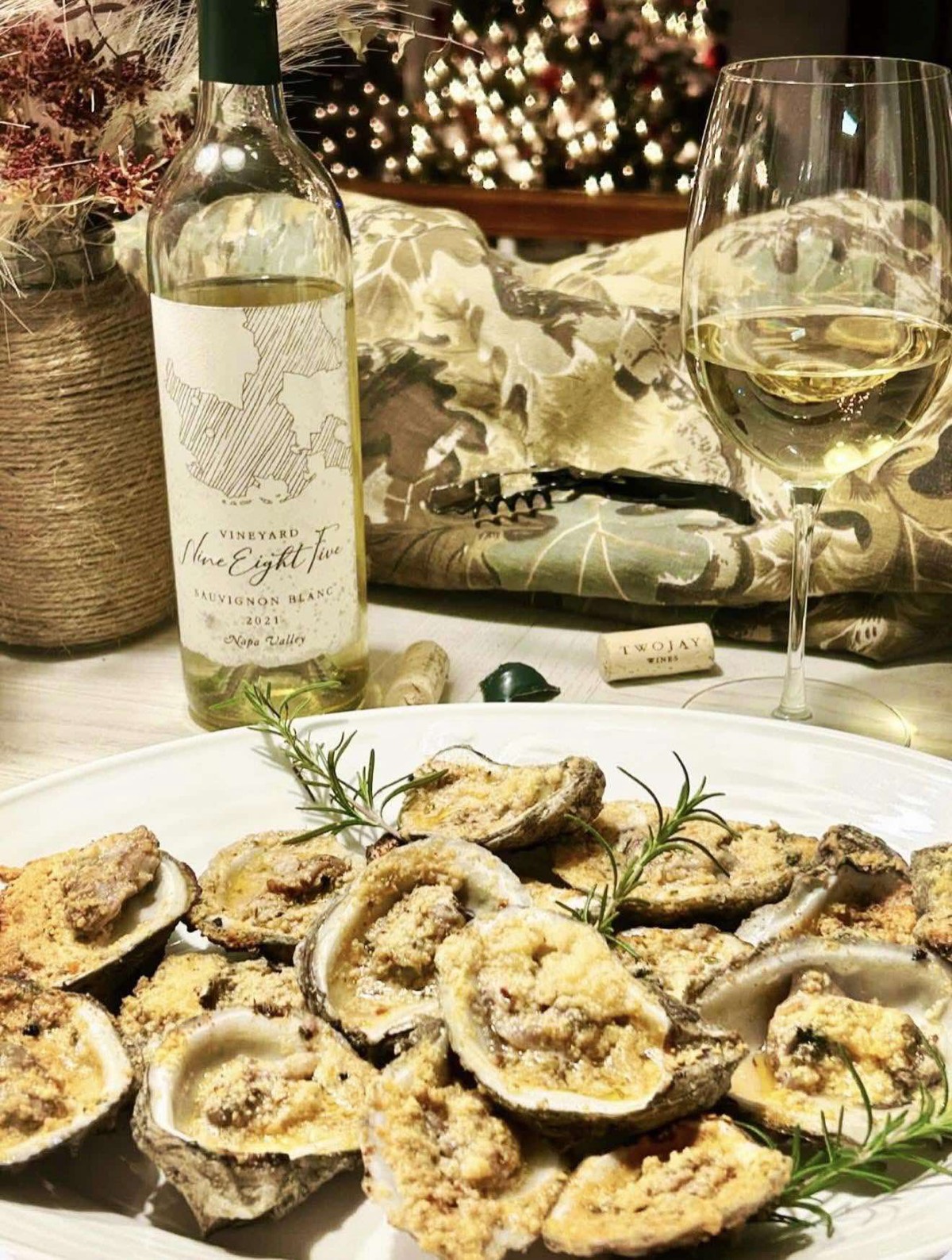 A chilled bottle of Sauvignon Blanc beside a platter of fresh oysters